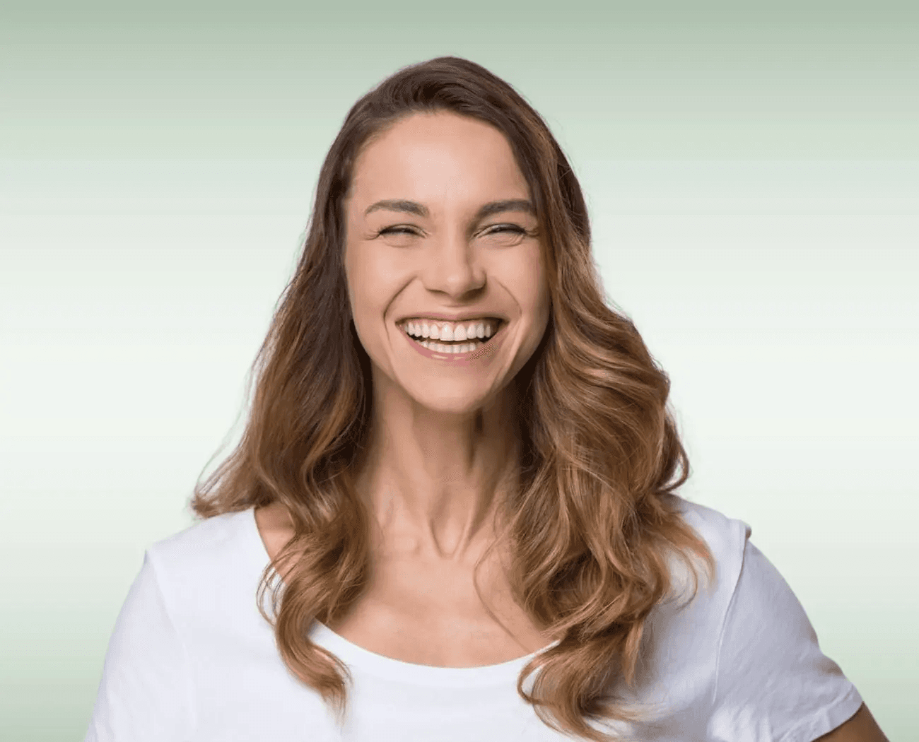Woman with a bright, natural smile after restorative dental crown treatment