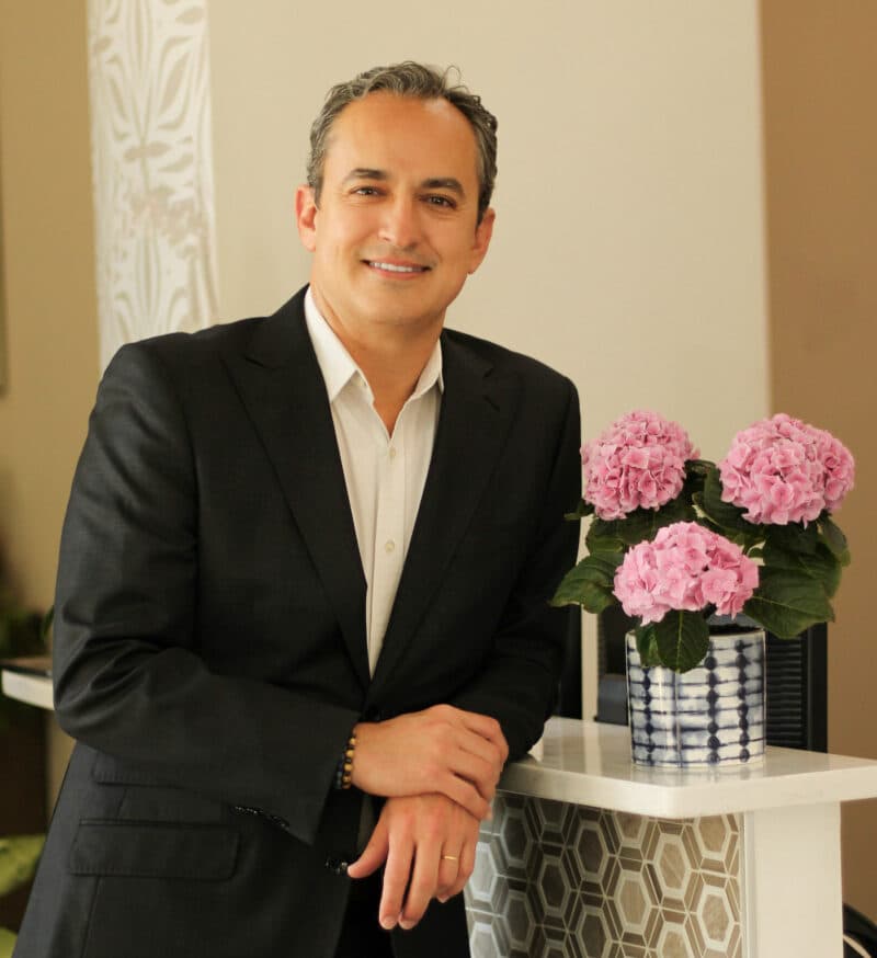 Dr. Daniel P. Jones, D.D.S., smiling in the reception area of Smile Beautiful Dental